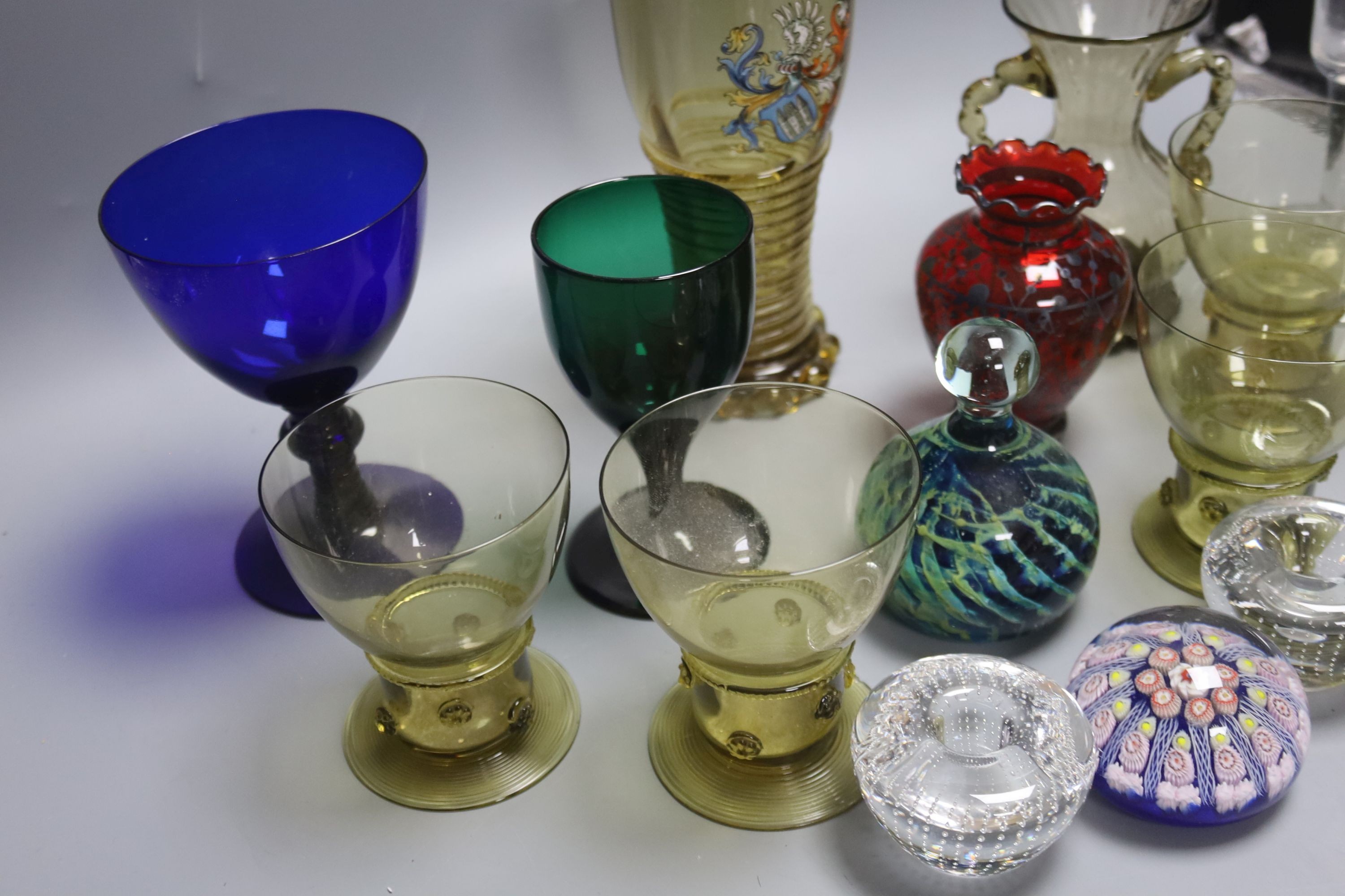 A German glass beaker with enamelled crest, 17.5cm, four Roemers, a millefiori paperweight and coloured glassware